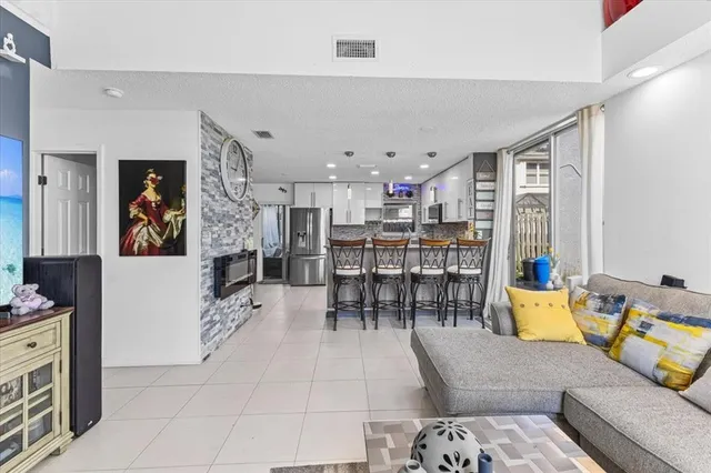 a living room with furniture and kitchen view