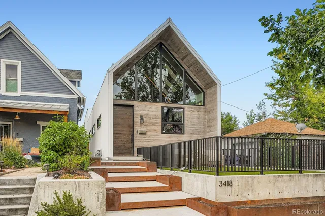 a view of a house with a small yard and plants