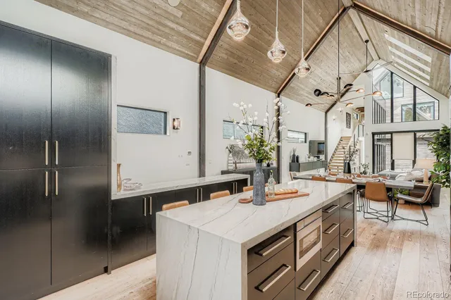 a living room with furniture and large windows