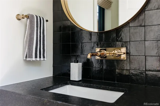 a kitchen with a sink and a wooden floor