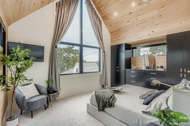 a bed room with a bed and a chair