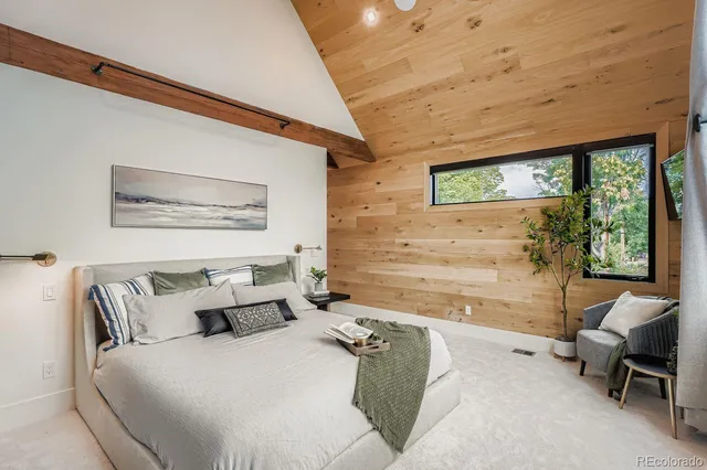 a bedroom with a bed and a potted plant