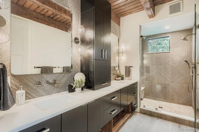 a bathroom with a double vanity sink and a mirror