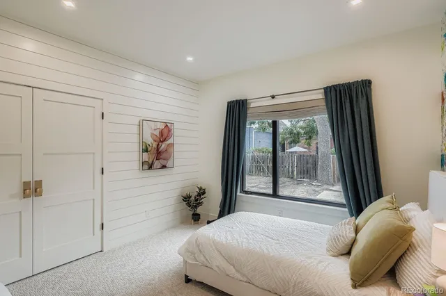 a kitchen with a sink a counter and a dining table with wooden floor