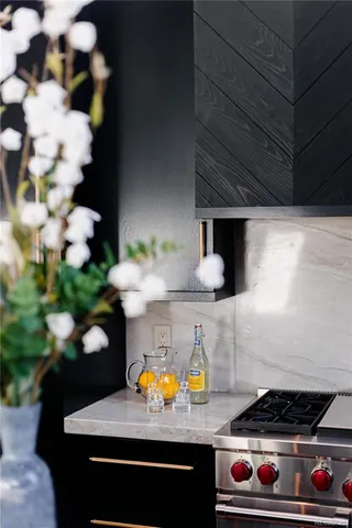 a bathroom with a sink a stove and flowers