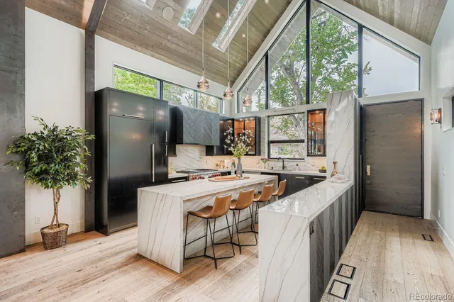 a kitchen that has a lot of cabinets and refrigerator
