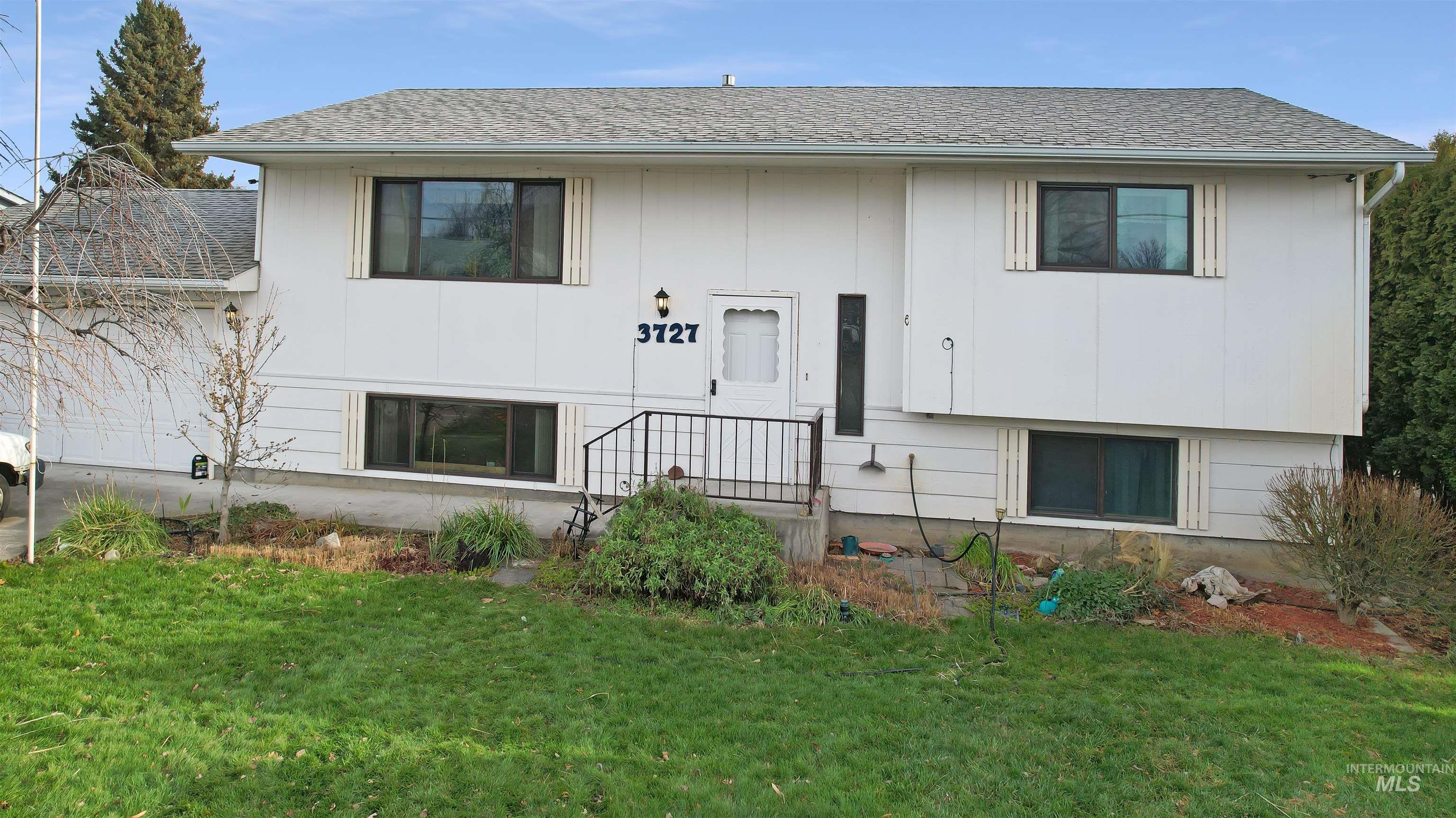 3727 17th Street Lewiston, ID 83501 - Photo 3 of 10 View of front of property with a front lawn and a shingled roof