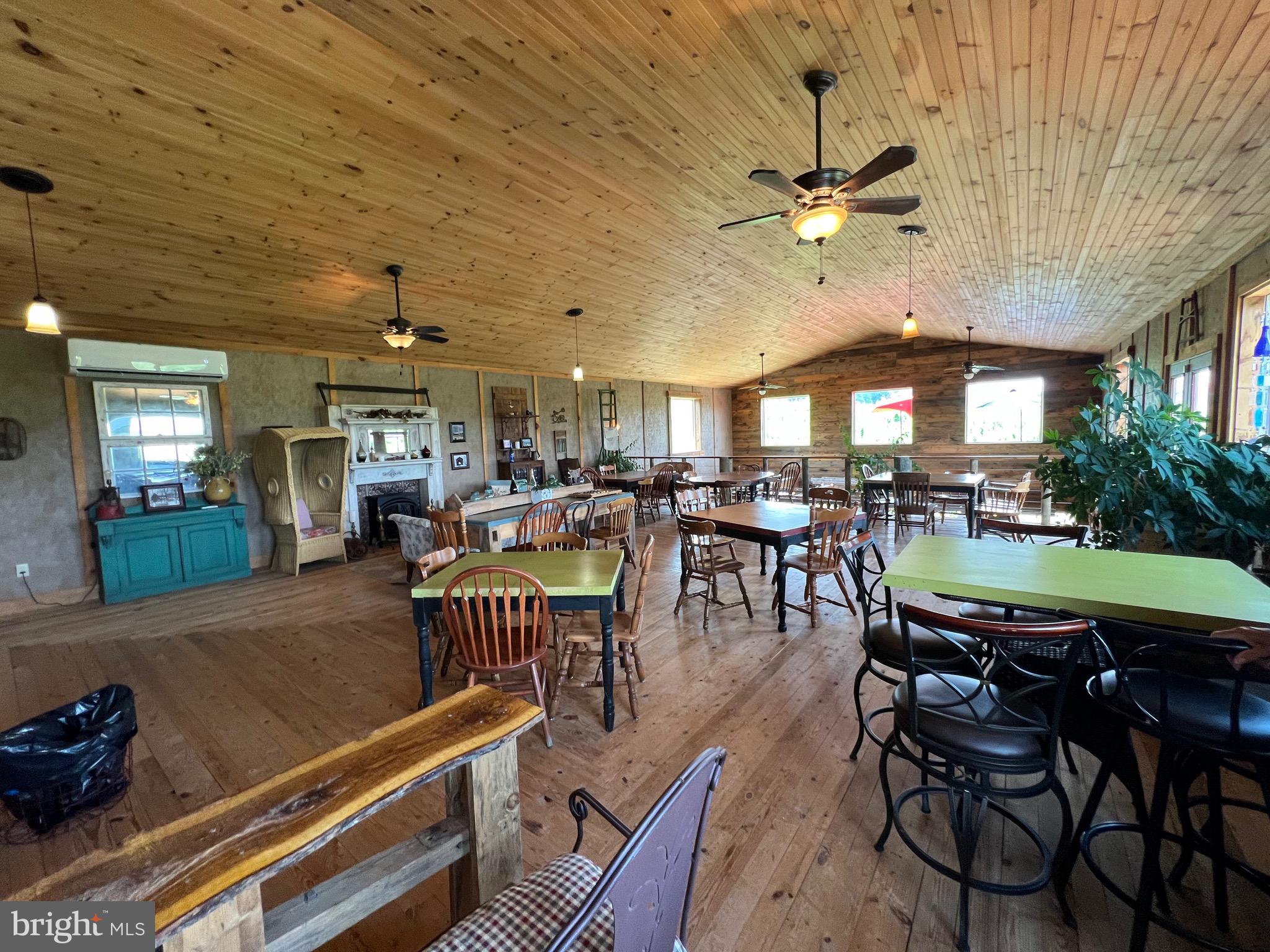 2110 Quicksburg Road Quicksburg, VA 22847 - Photo 35 of 54 a dining hall with couches a dining table and chairs with outer view