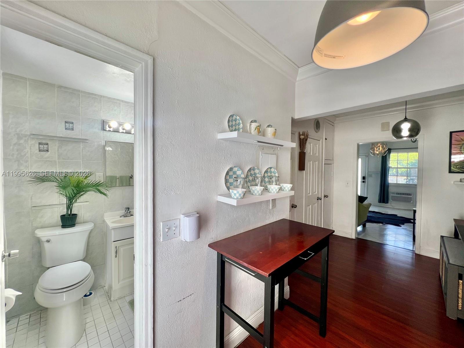 330 74th Street, Unit 5 Miami Beach, FL 33141 - Photo 10 of 19 a living room with a table and chairs