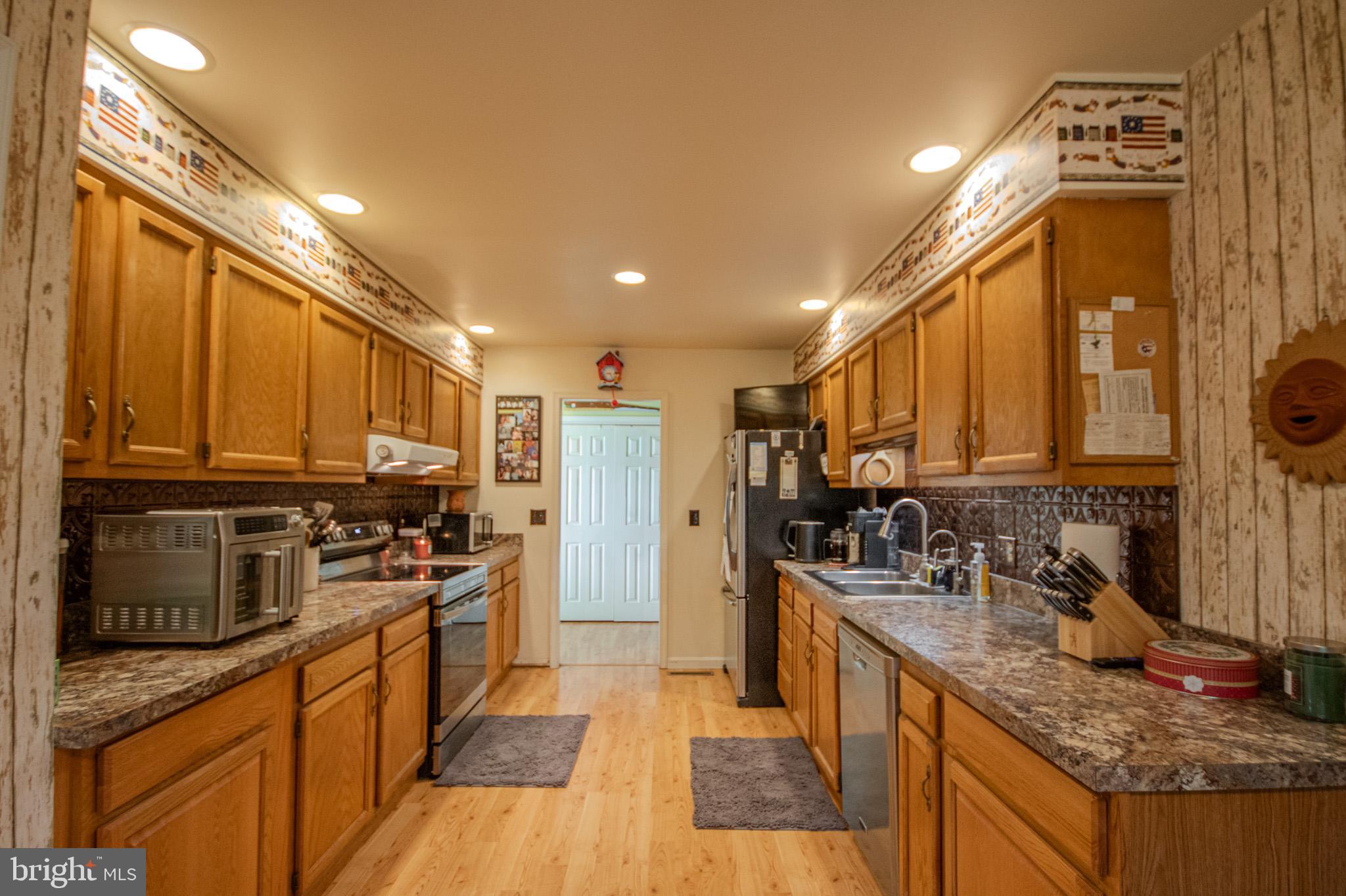 5520 Cedarcrest Road Salisbury, MD 21801 - Photo 15 of 41 a kitchen with stainless steel appliances granite countertop a sink stove and refrigerator