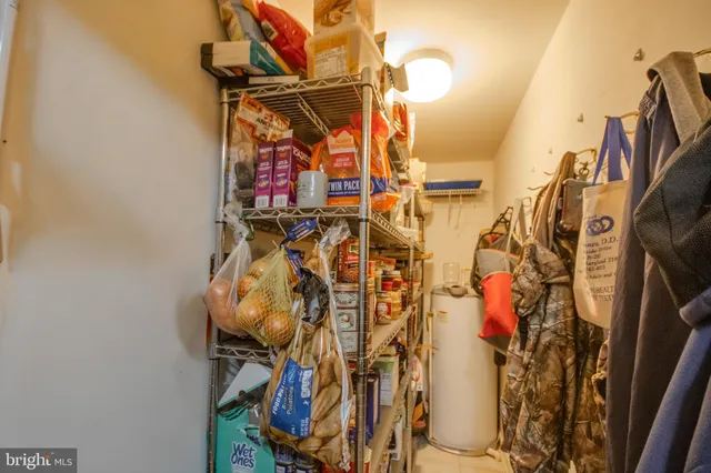 a view of walk in closet with clothes