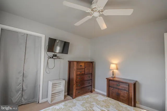 a view of a livingroom with furniture and a chandelier fan