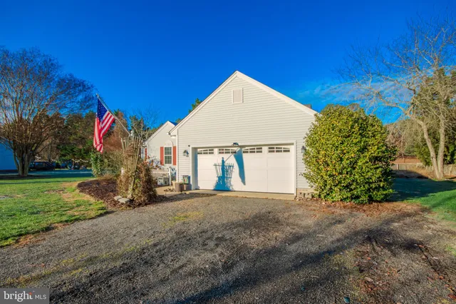 a view of a house with a yard and garage
