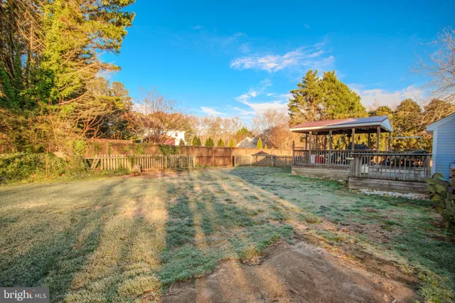 a view of backyard of house with green space