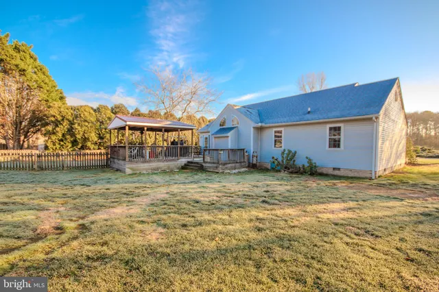 an aerial view of a house with garden space and street view