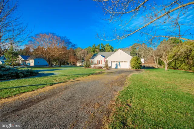 a view of house with backyard and trees