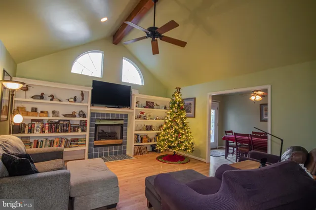 a living room with furniture cabinets and a flat screen tv