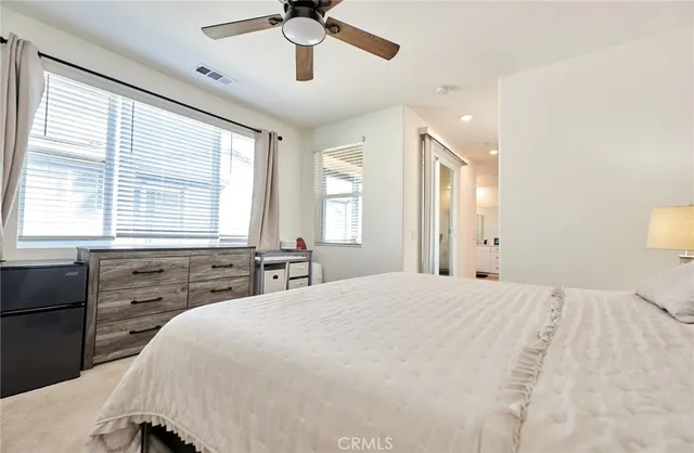 a bedroom with a bed and a night stand