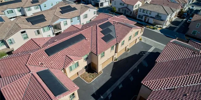 an aerial view of a house with swimming pool and furniture