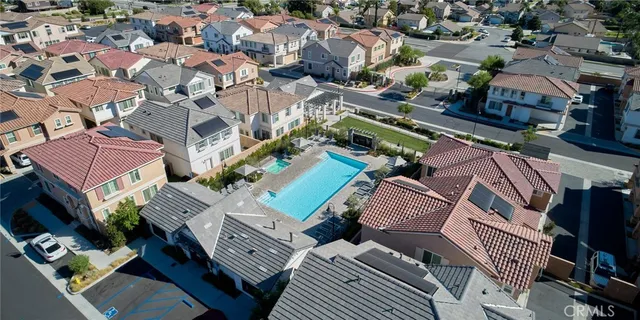 an aerial view of residential houses with outdoor space