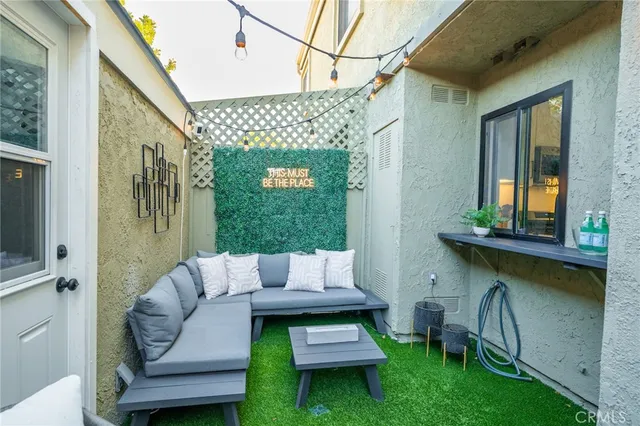 a view of a patio with table and chairs potted plants