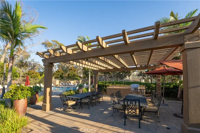 a view of a patio with chairs and wooden fence