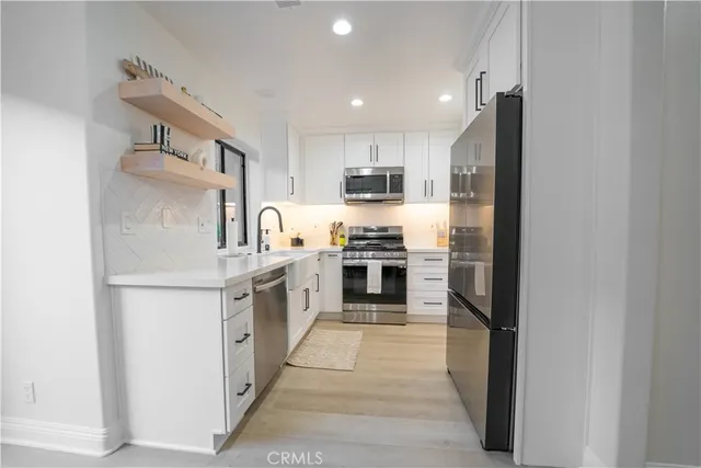 a bathroom with a sink mirror vanity and toilet