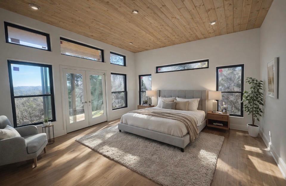 216 Old Orchard Road Ellijay, GA 30536 - Photo 20 of 59 a spacious bedroom with a bed a couch and a large window