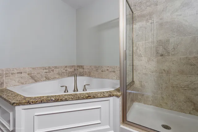 a bath tub sitting next to a shower