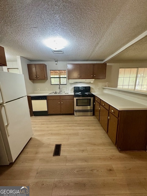 1769 Duncan Road Commerce, GA 30530 - Photo 4 of 16 a large kitchen with stainless steel appliances granite countertop a stove a sink dishwasher and a refrigerator with wooden floor