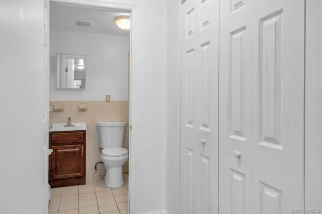 a bathroom with a toilet sink and a mirror