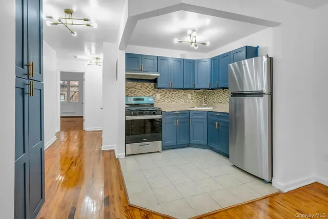 a kitchen with kitchen island a counter top space appliances and cabinets
