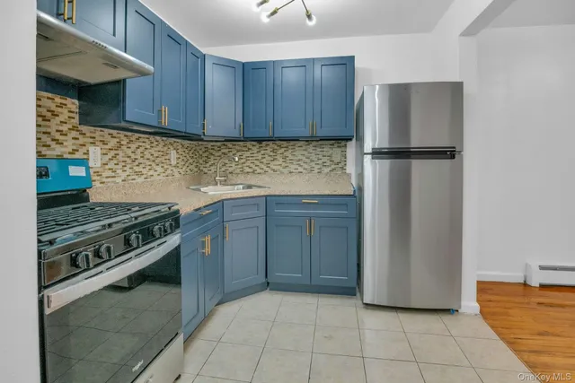 a kitchen with a stove and a refrigerator