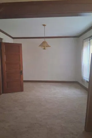 a view of an empty room with closet