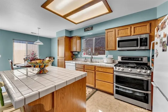 a kitchen with a stove a sink and a microwave