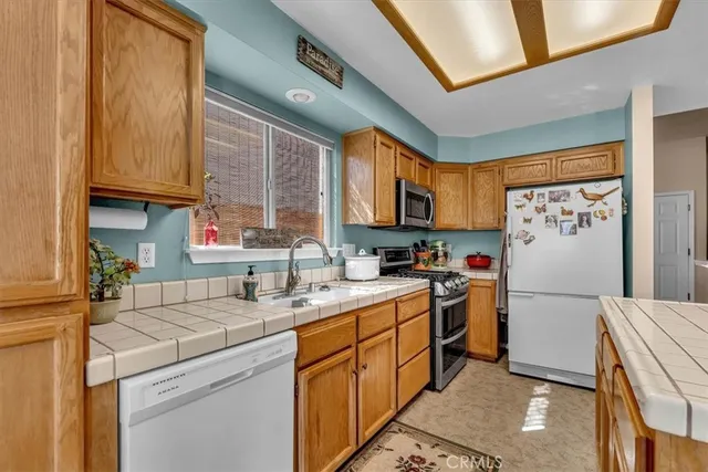 a kitchen with a sink cabinets and appliances