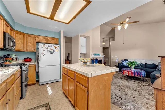 a kitchen with refrigerator and cabinets