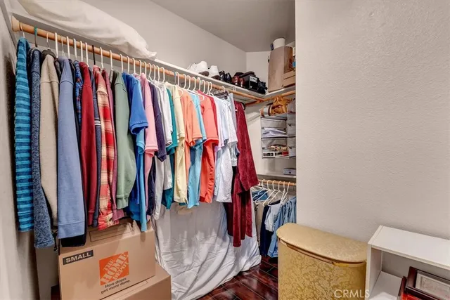 a view of walk in closet with clothes