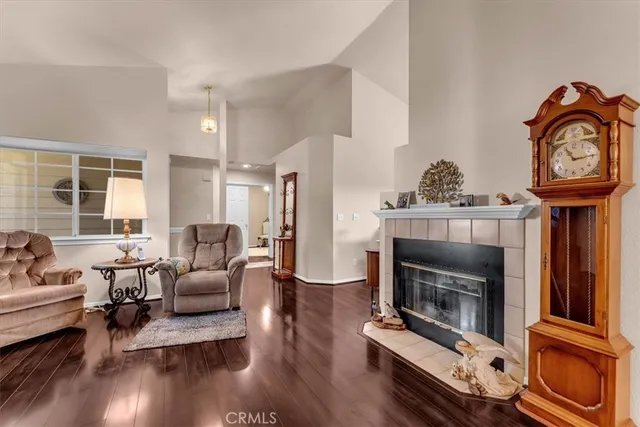 a living room with furniture a fireplace and wooden floor