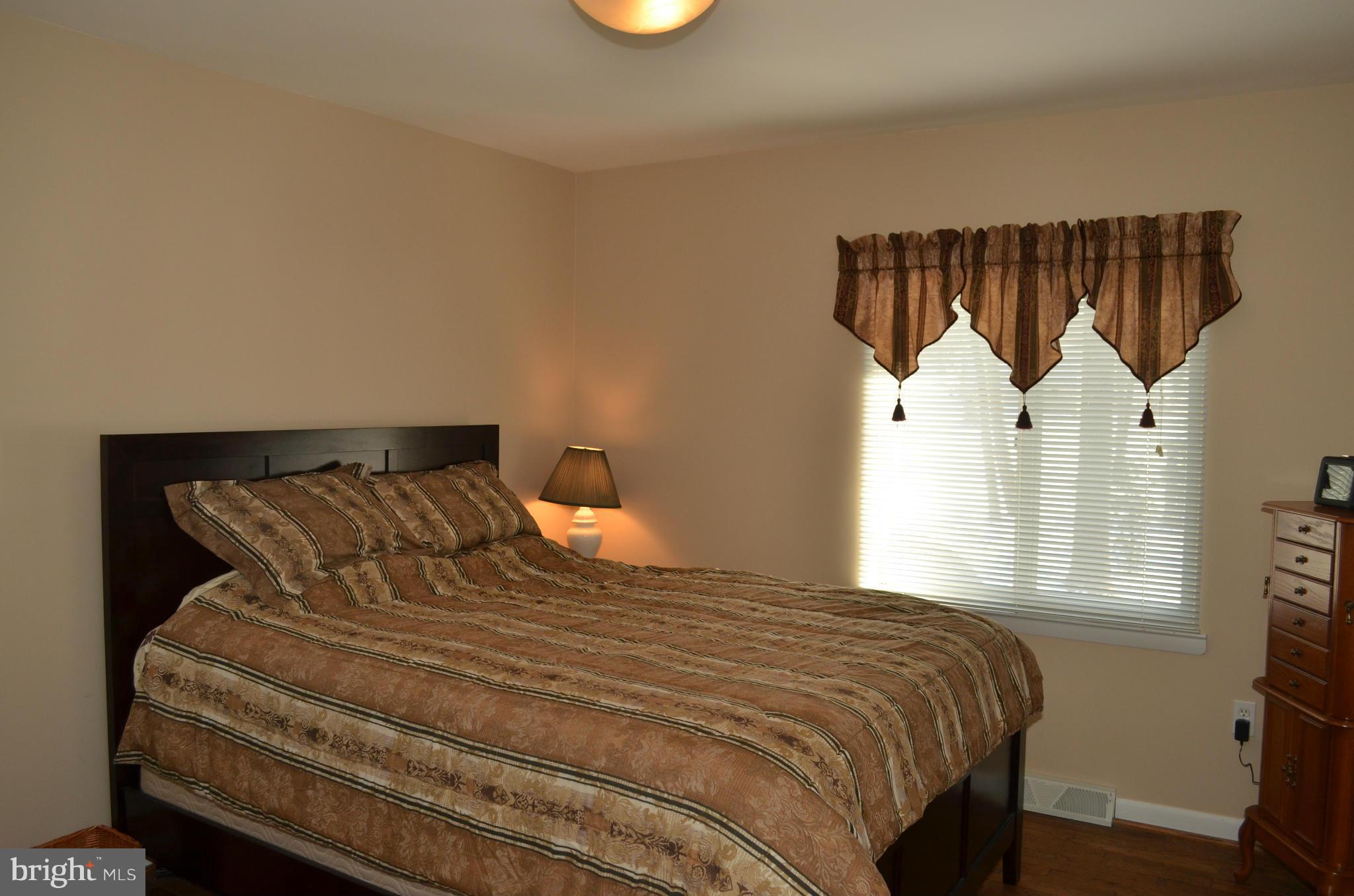14314 Dairydale Road Baldwin, MD 21013 - Photo 22 of 27 a bedroom with a bed a window and a chandelier