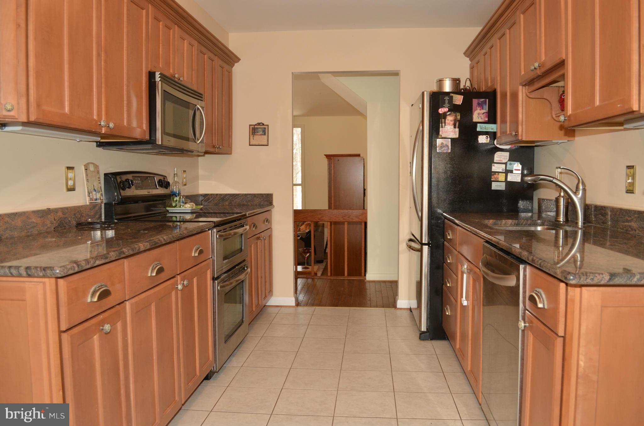 14314 Dairydale Road Baldwin, MD 21013 - Photo 7 of 27 a kitchen with stainless steel appliances granite countertop a sink stove and refrigerator