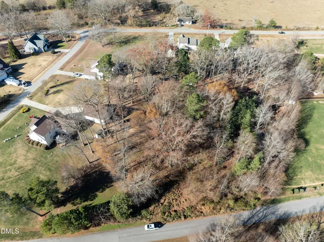 a view of a yard with wooden fence