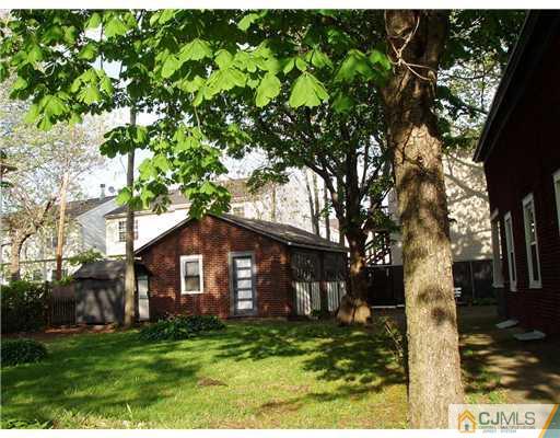 12 Hudson Street Carteret, NJ 07008 - Photo 2 of 2 a house with green field in front of it