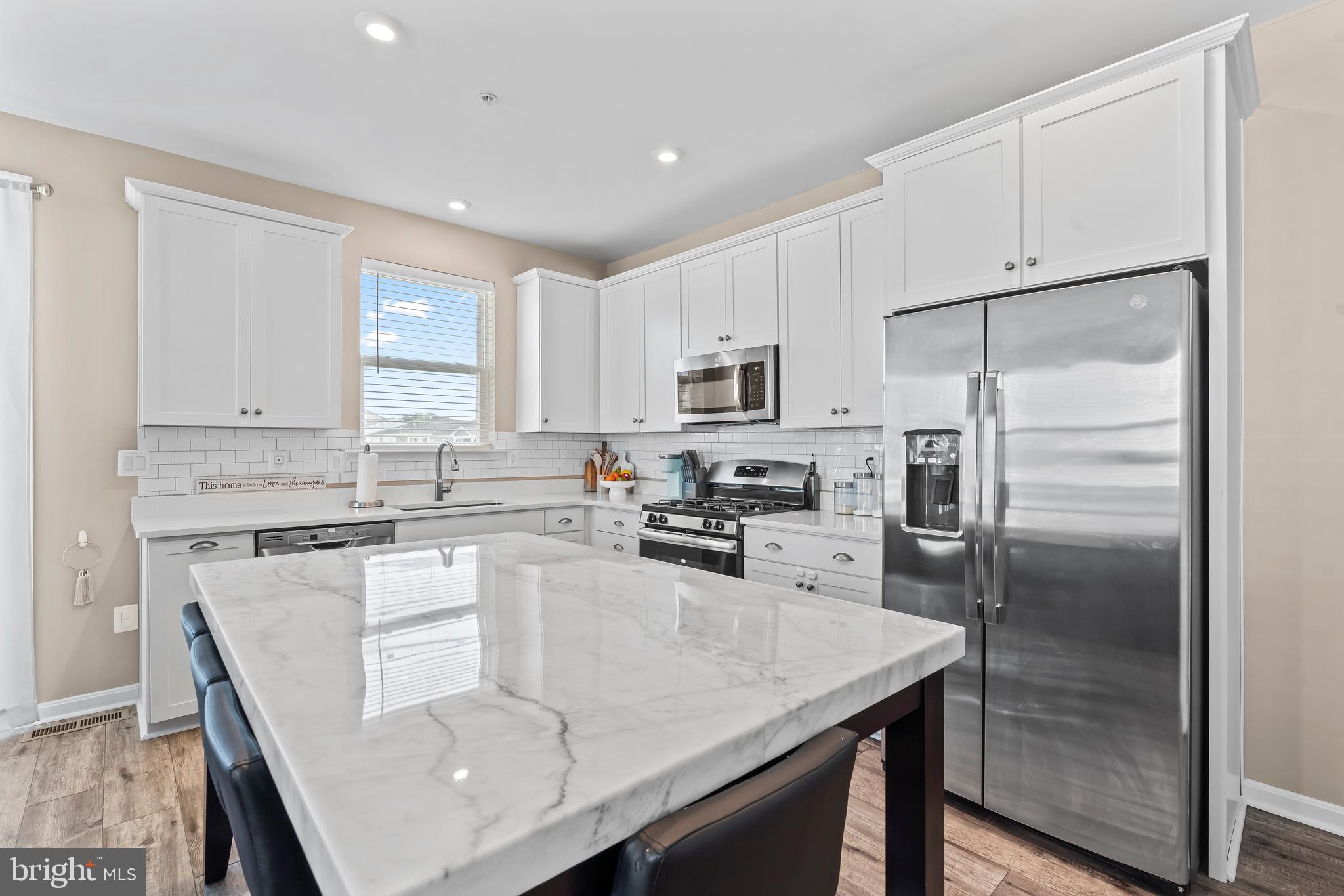 17330 Kilpatrick Court Hagerstown, MD 21740 - Photo 18 of 31 a kitchen with stainless steel appliances granite countertop a refrigerator a stove a sink a dining table and chairs