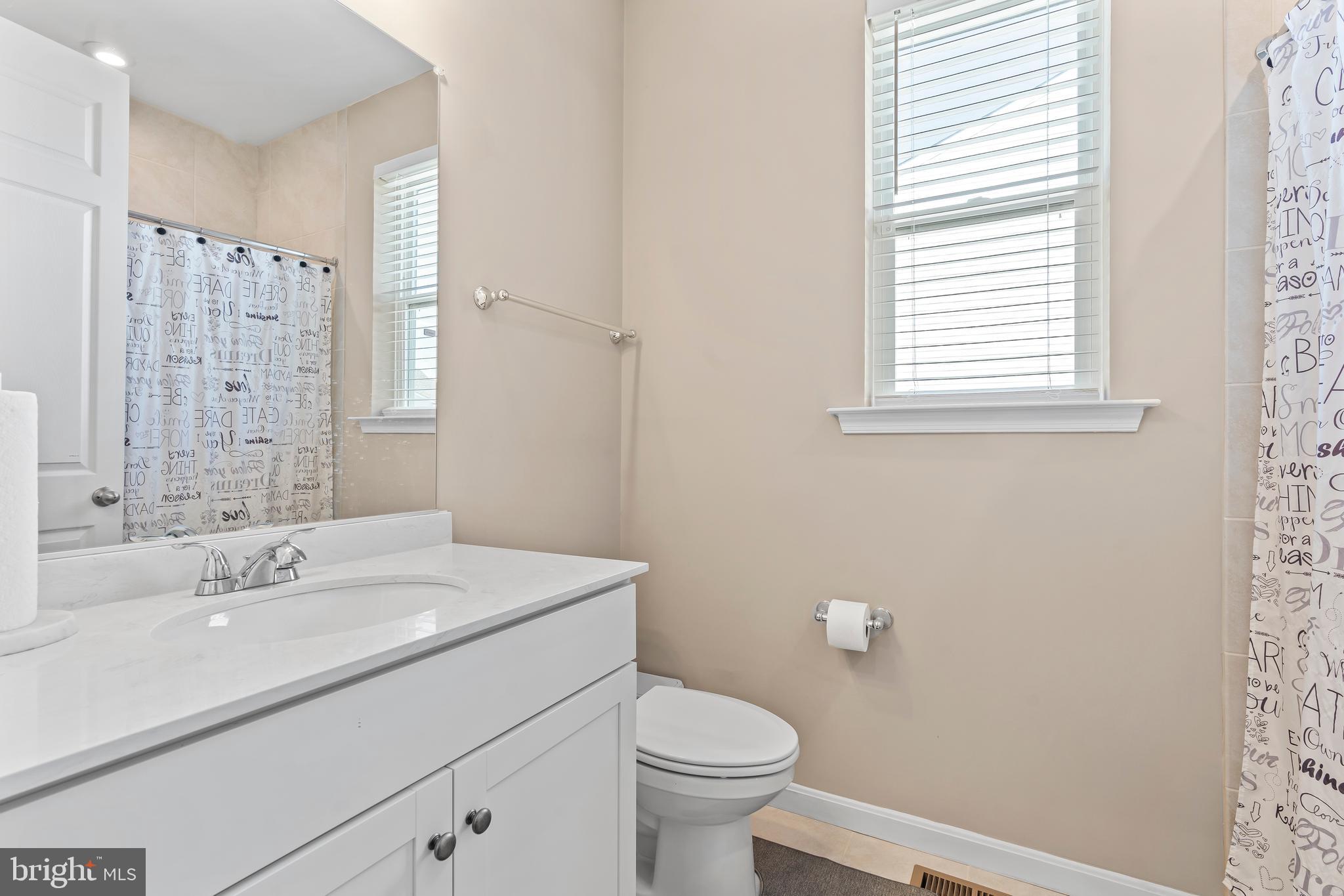 17330 Kilpatrick Court Hagerstown, MD 21740 - Photo 29 of 31 a bathroom with a sink a toilet and a mirror