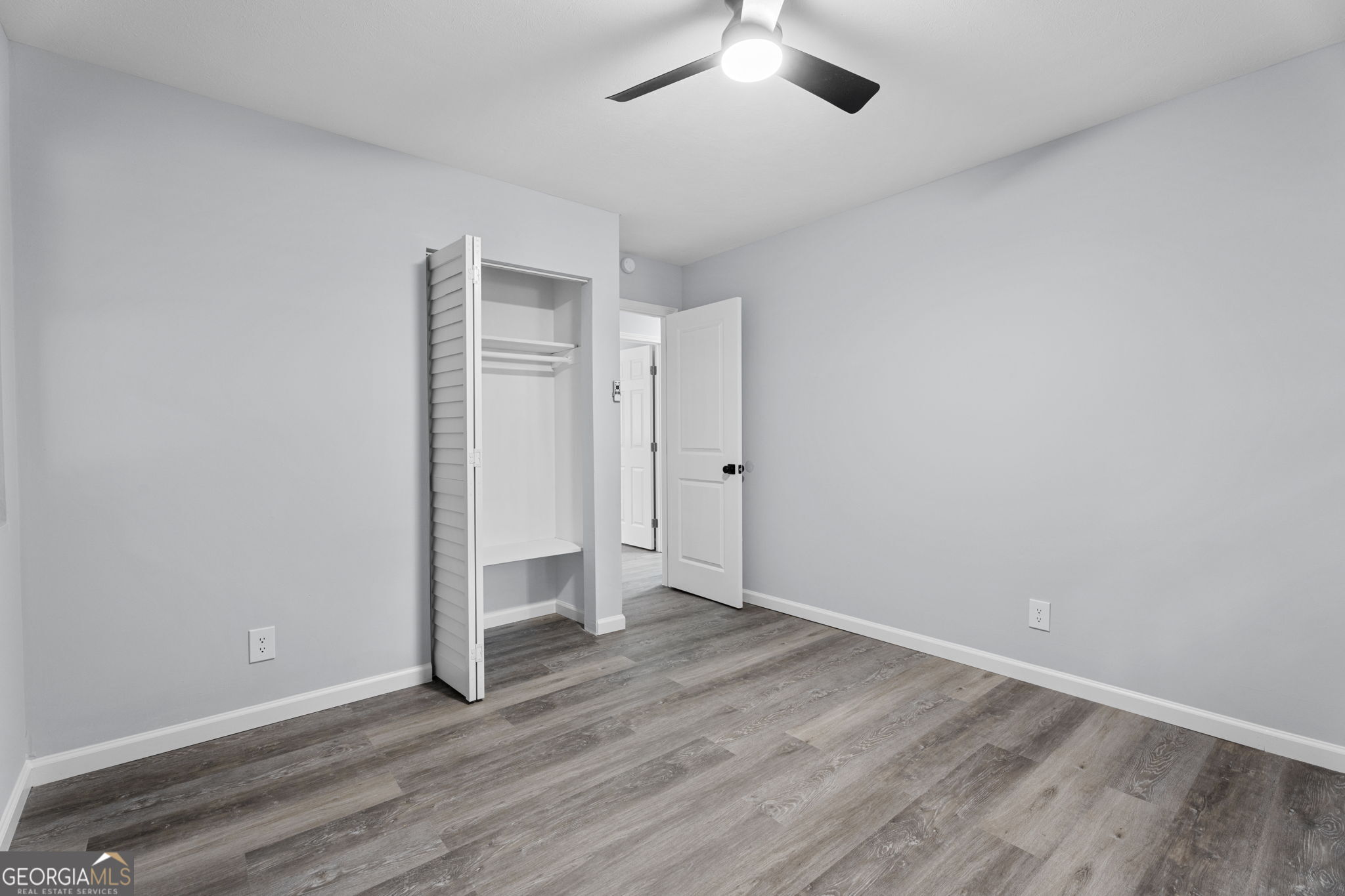 6463 Maddox Road Morrow, GA 30260 - Photo 25 of 46 an empty room with wooden floor and natural light