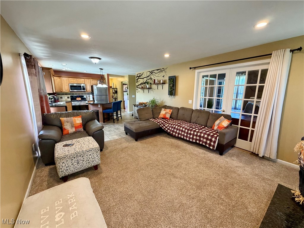 7374 Virginia Road Atwater, OH 44201 - Photo 15 of 49 Living room featuring recessed lighting, light colored carpet, and french doors