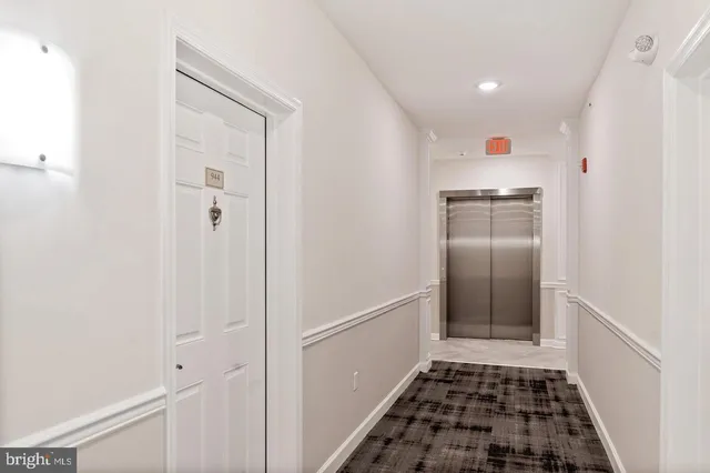 a kitchen with white cabinets and appliances