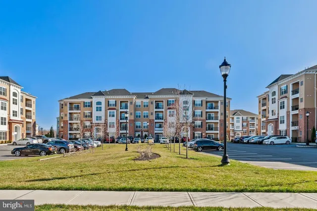 a front view of a building with a garden