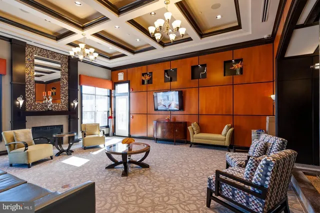 a living room with furniture a rug and a large window